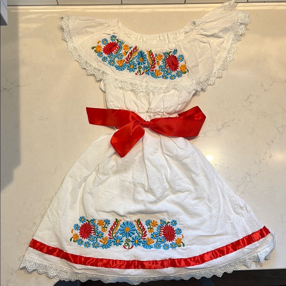 White Dress with Floral Embroidery and Red Bow